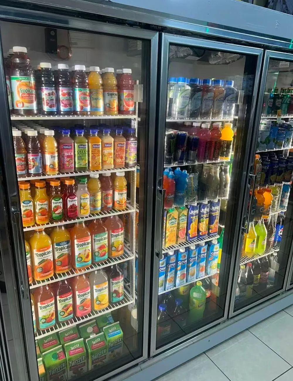 Refrigerated coolers filled with assorted drinks at 105 Mini Market, a Supermarket & Fast Food Spot in Corona