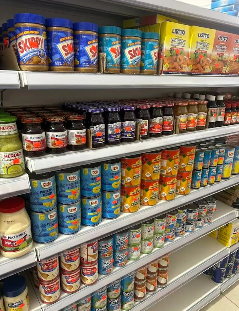 Shelves stocked with pantry staples and condiments at 105 Mini Market, a Supermarket & Fast Food Spot in Corona