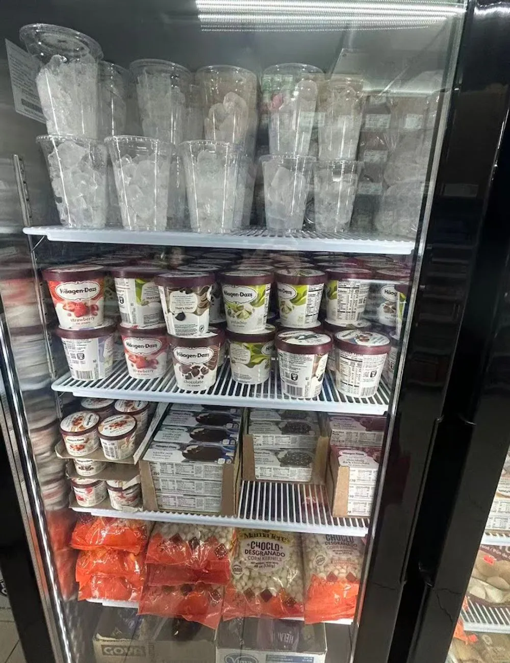Freezer display with ice cream cups and treats at 105 Mini Market, a Supermarket & Fast Food Spot in Corona