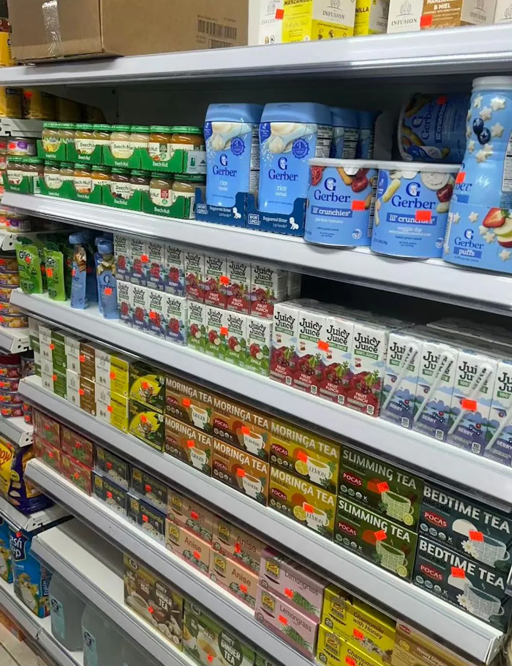 Shelves with baby food, juices, and herbal teas at 105 Mini Market, a Supermarket & Fast Food Spot in Corona